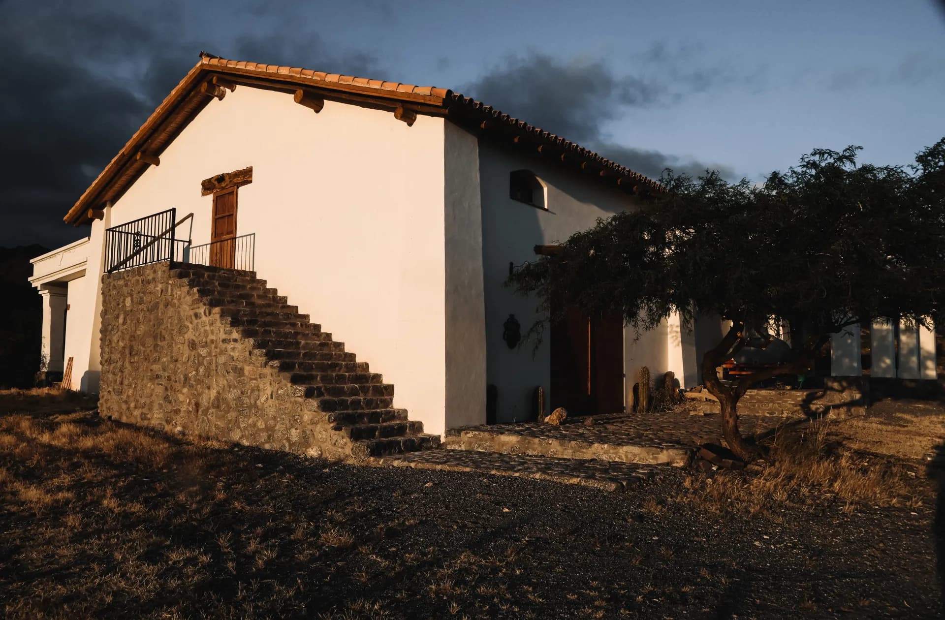 Arca Yaco bodega facade at sunset with stone staircase